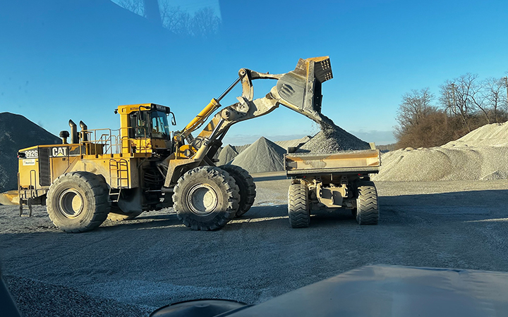 Site material handling with heavy equipment